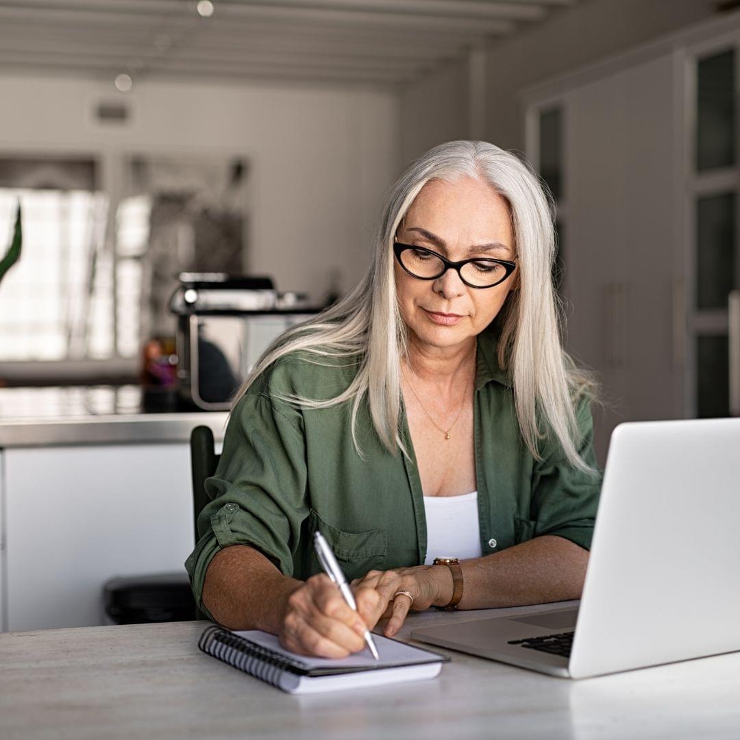 A woman writing on her laptop
